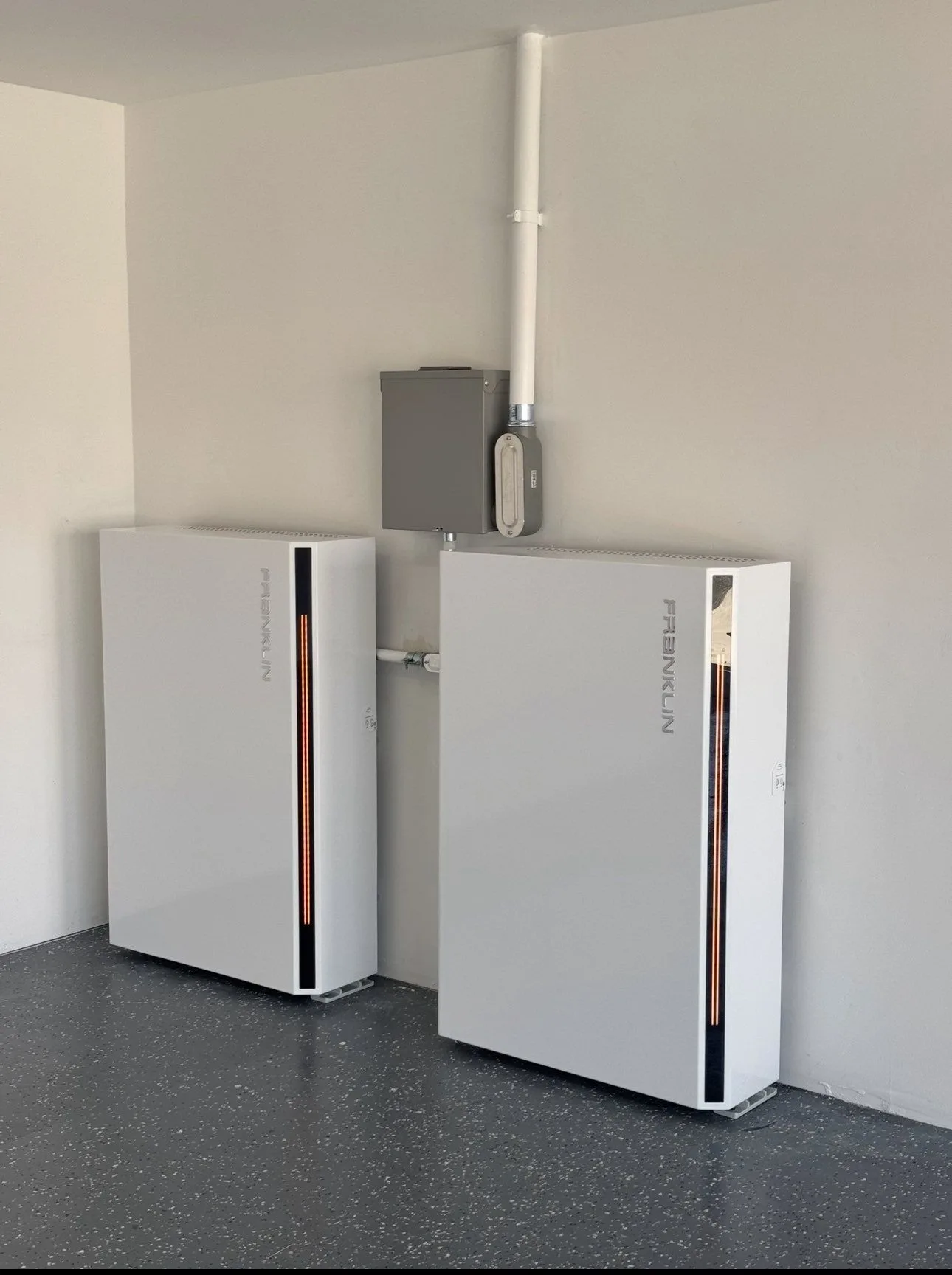Two Franklin batteries installed side by side in a finished garage.