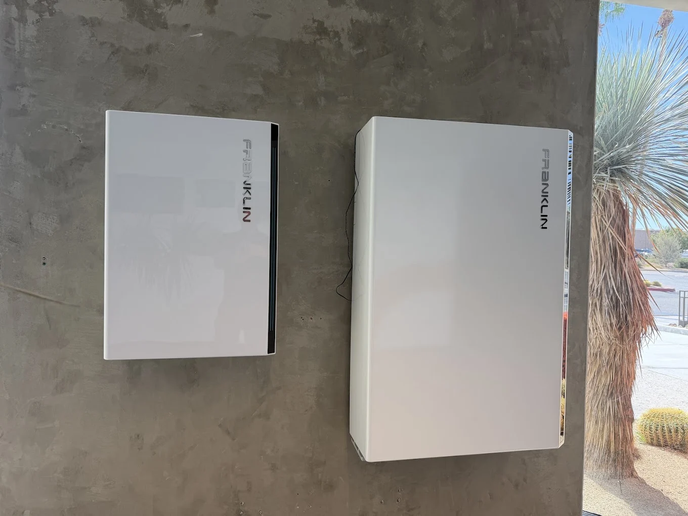 Close-up of wall-mounted battery and inverter equipment displayed inside the Mycrogrid office
