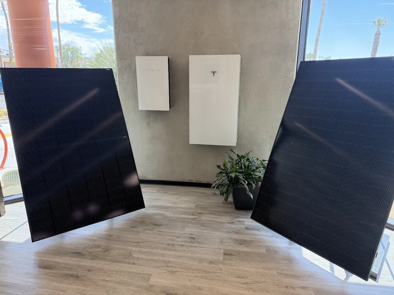 Solar panels and wall-mounted battery equipment displayed inside the Mycrogrid office
