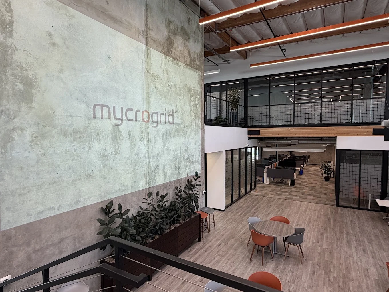 Mycrogrid office atrium with the company logo projected across a concrete wall