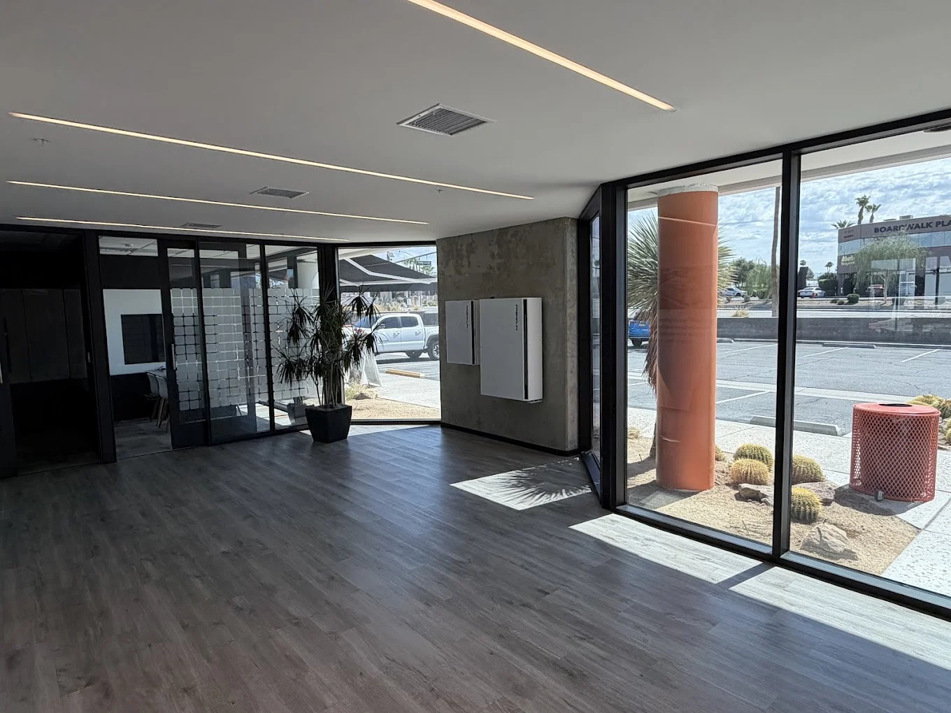 Mycrogrid® office entry with displayed solar and battery equipment visible beside the front windows